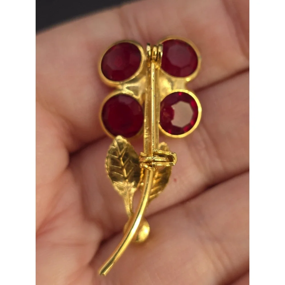 vintage gold-toned floral brooch with red and pink glass rhinestones